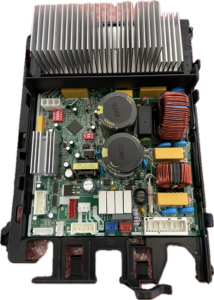 Open electronic control module with large silver heatsink and exposed circuit board components