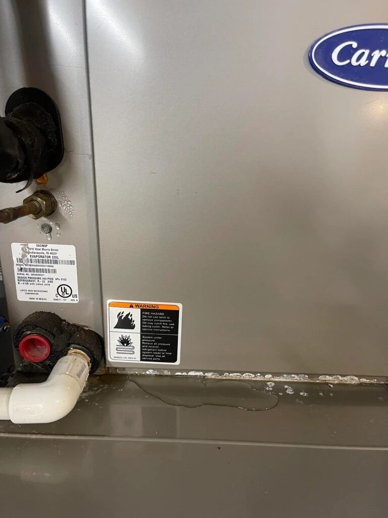 Close-up of industrial equipment with pipes, valves, and warning labels on a metal panel.