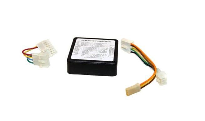 Black electronic control module with multicolored wire connectors on a white background