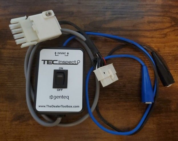 TEC2 controller module with white and blue wiring harnesses on a wooden surface