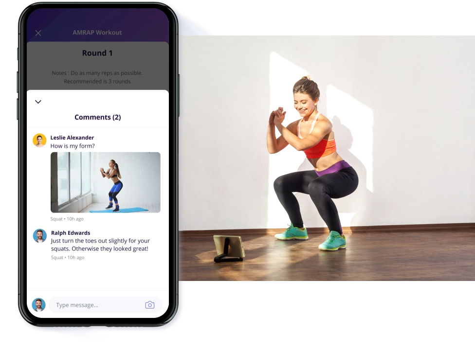 A woman is squatting on a yoga mat next to a cell phone.