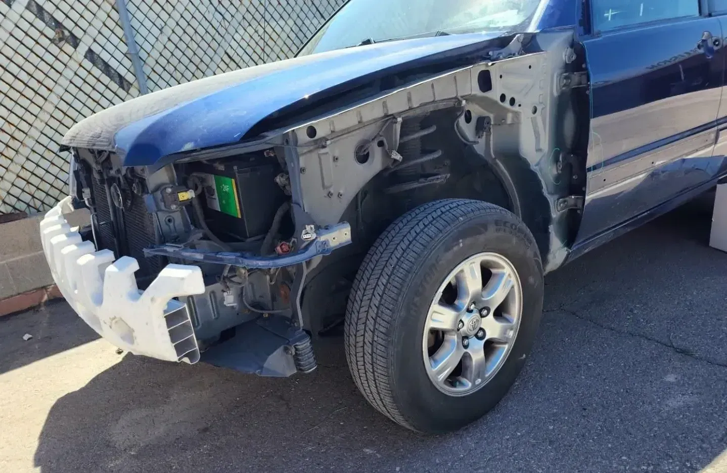 A blue truck that has been in a collision