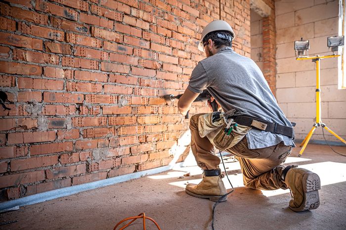 handyman construction site process drilling wall