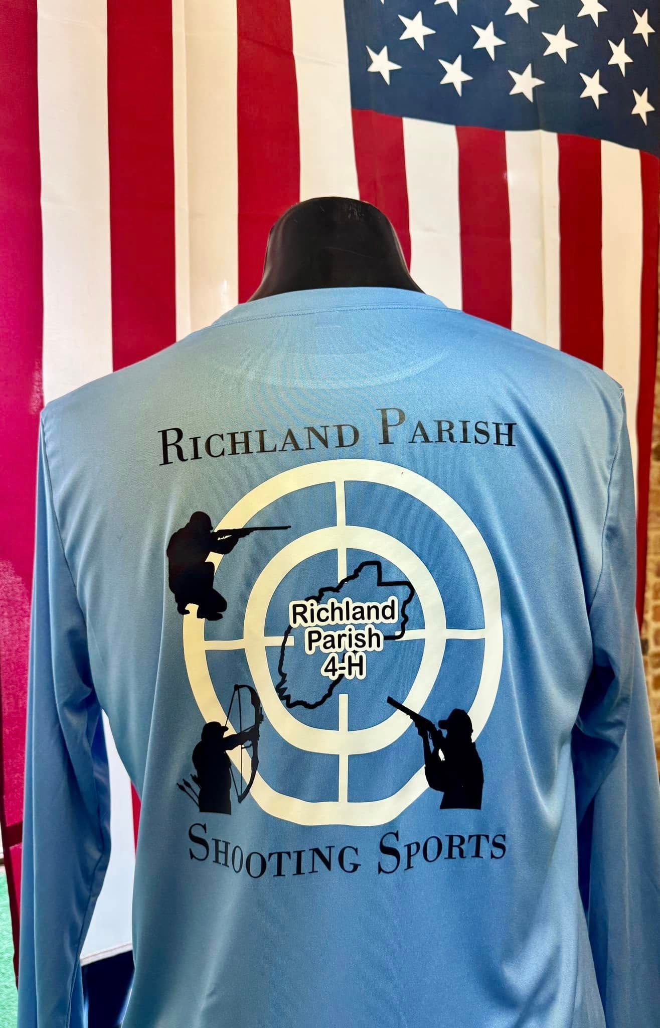 A blue shirt with a target on the back is on a mannequin in front of an american flag.