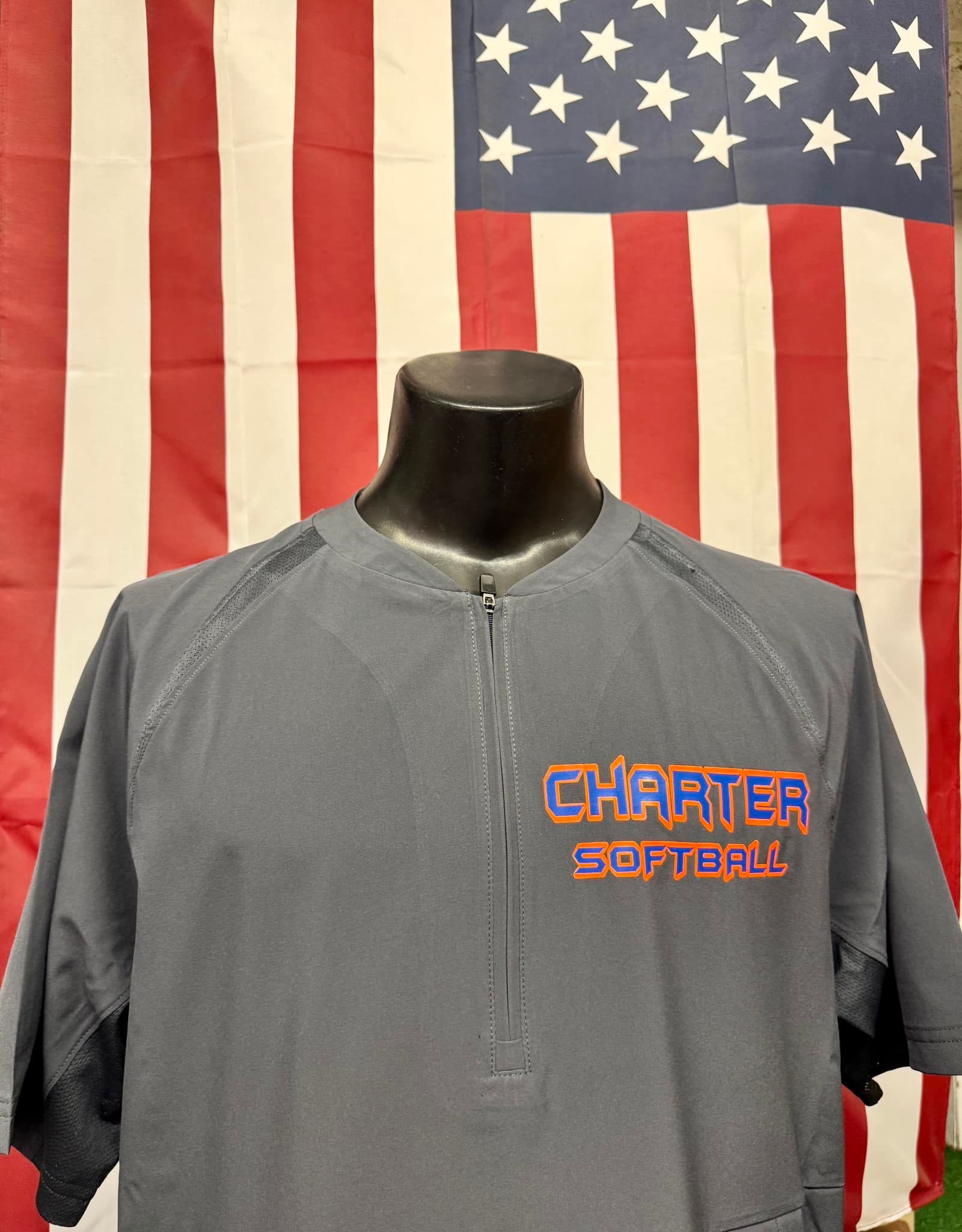 A charter softball shirt is on a mannequin in front of an american flag.