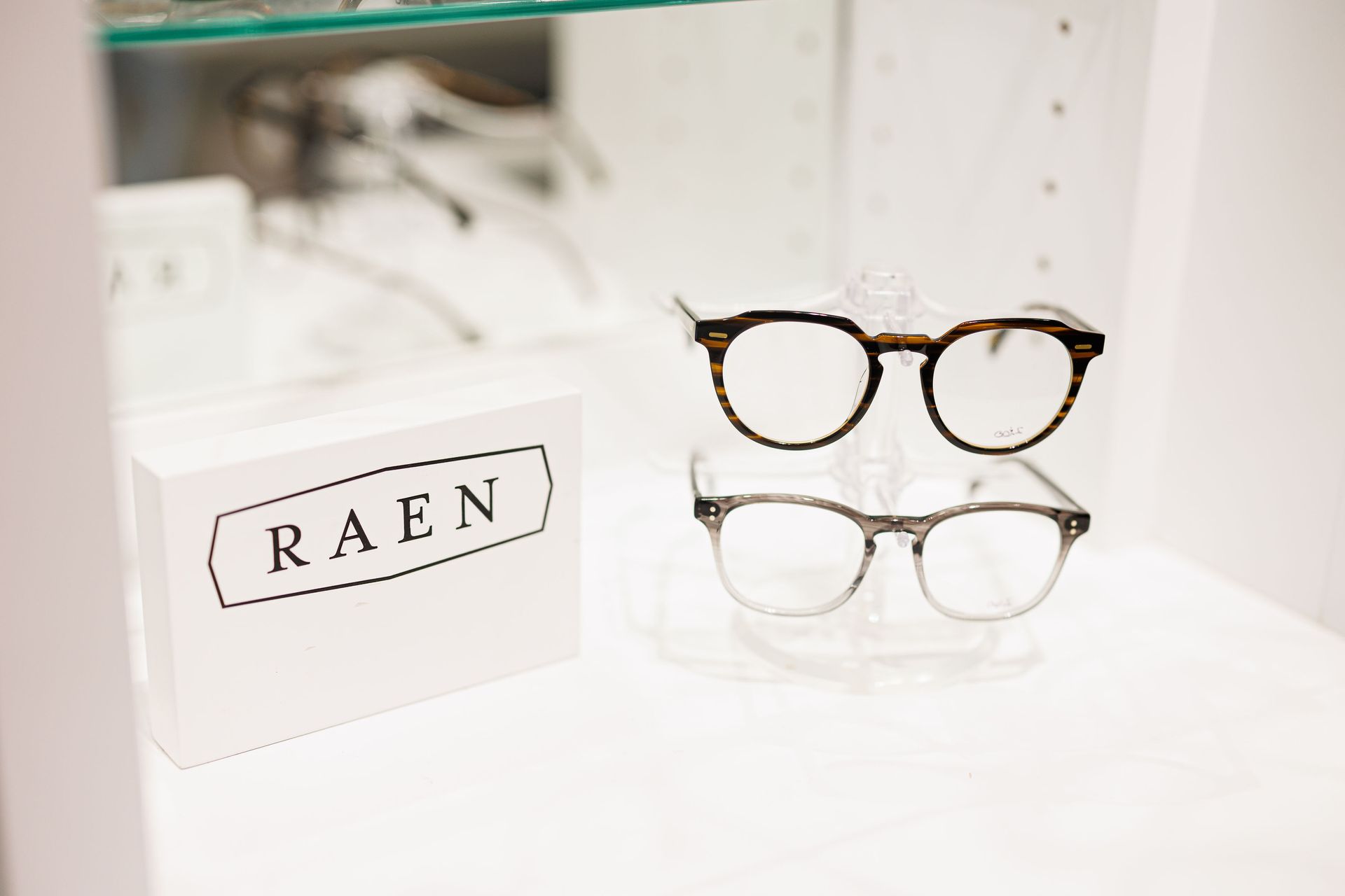 A table with glasses and sunglasses on it.