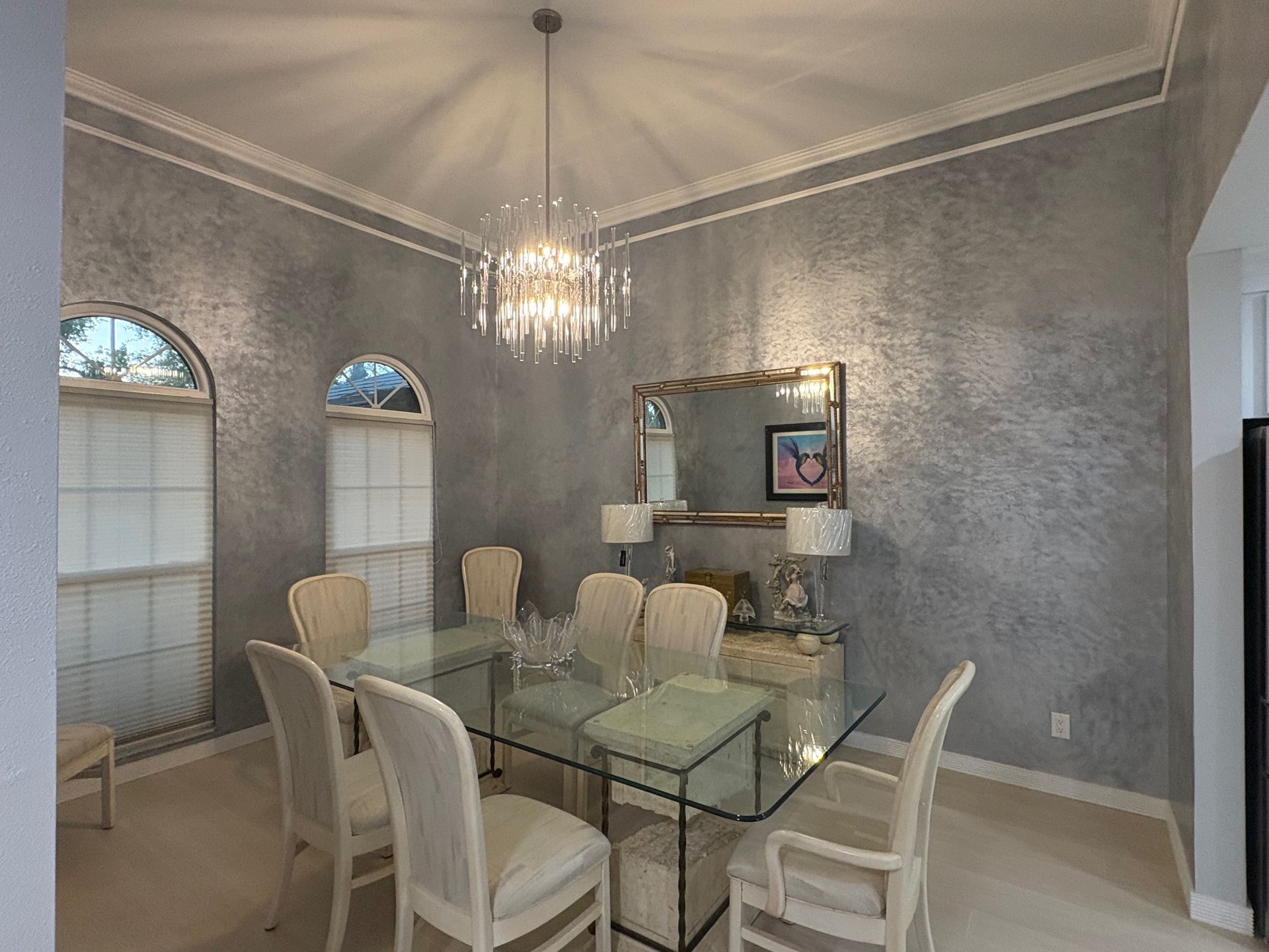 Smooth Venetian plaster wall in a bathroom with gold towels and art