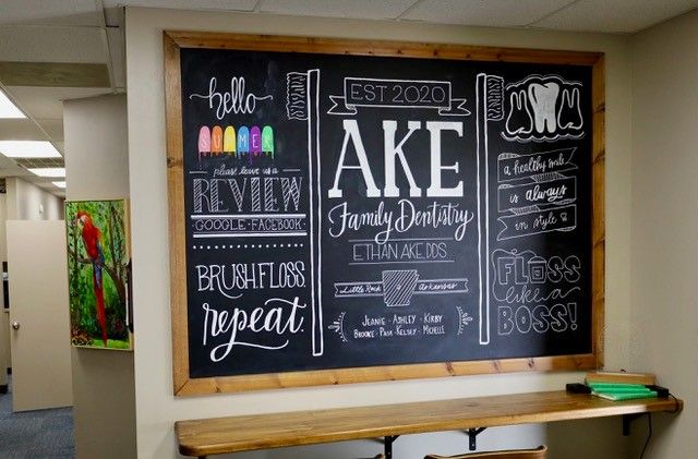 a chalkboard in a dental office that says brush floss repeat