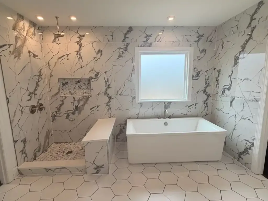 A high-angle view showing a diagonal transition between black marble floor tiles and light, marble-veined tile planks.