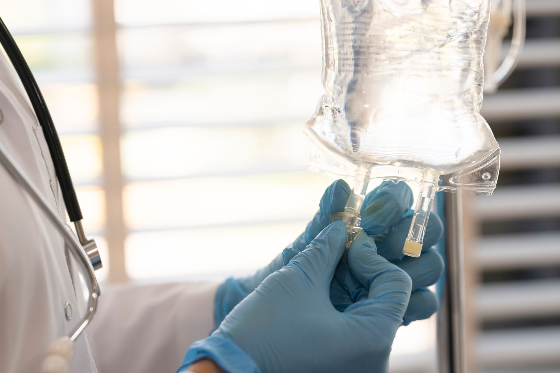 A doctor is preparing an intravenous drip for a patient.