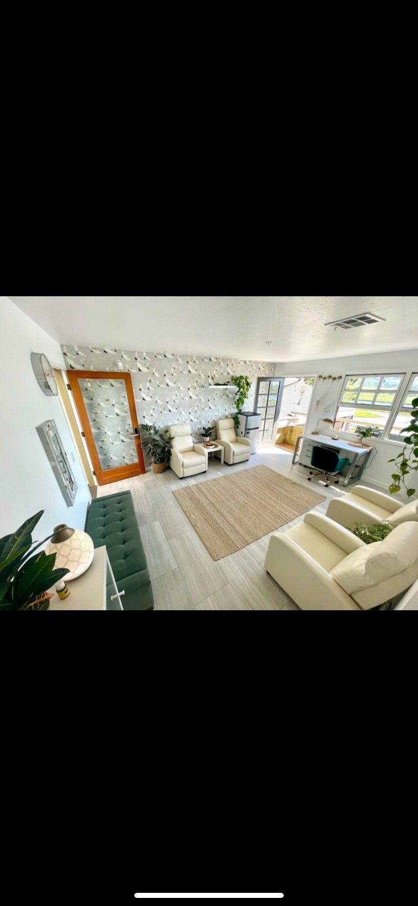 A living room filled with furniture and a rug.
