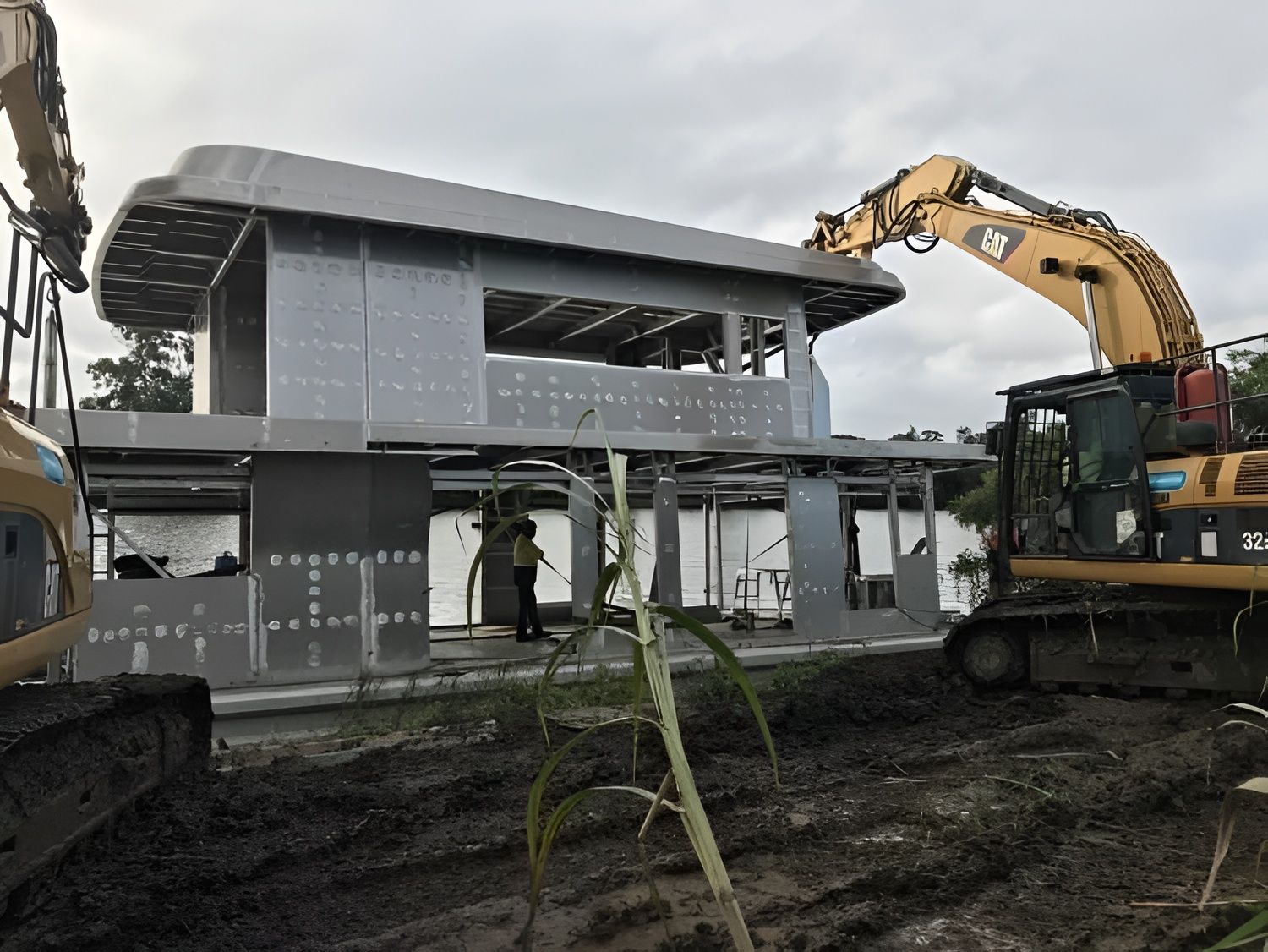 Construction Site With Excavator Placing a Structure — Compass Equipment Hire in the Northern Rivers, NSW