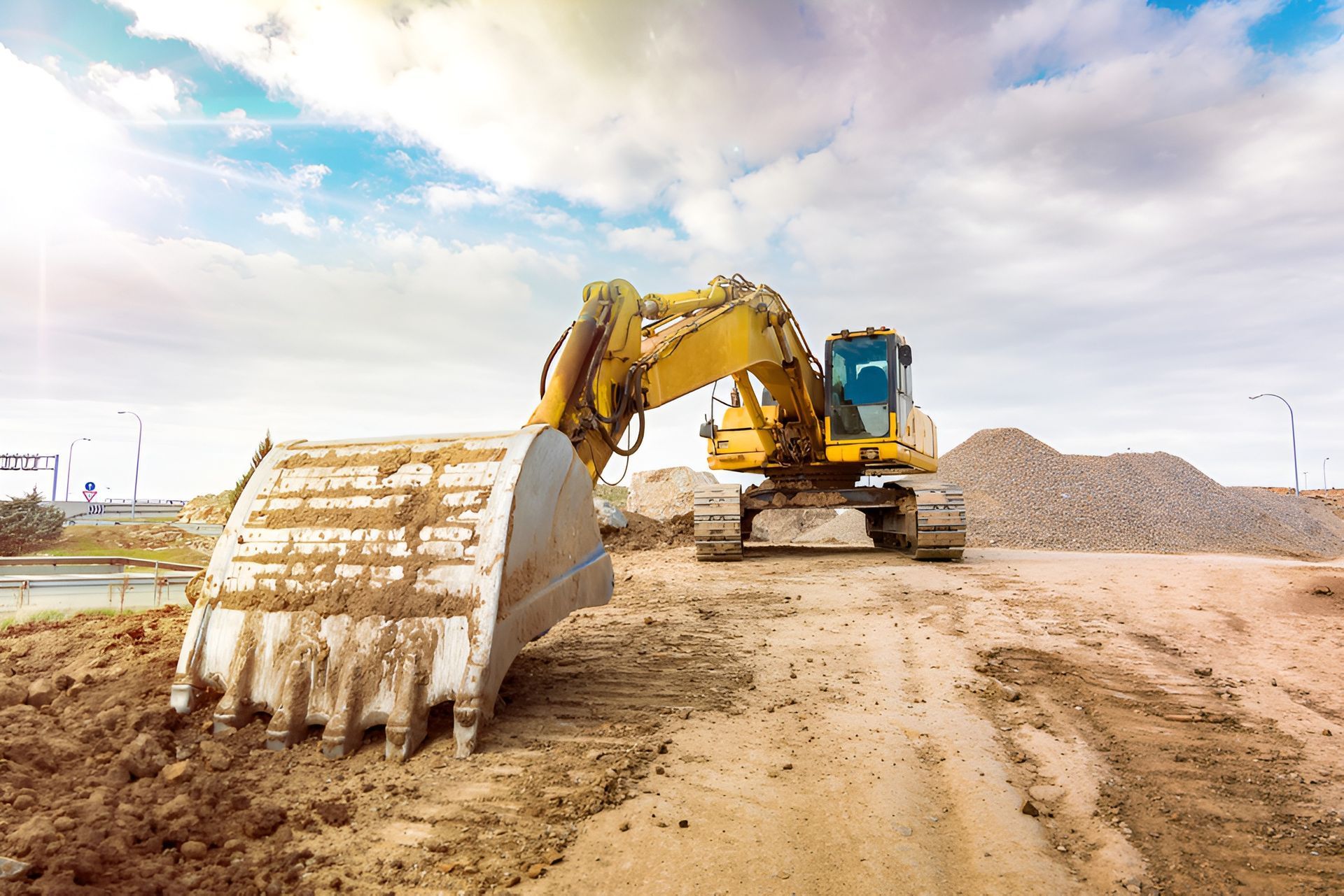 Yellow Excavator Scoops Earth at a Construction — Compass Equipment Hire in Coffs Harbour, NSW