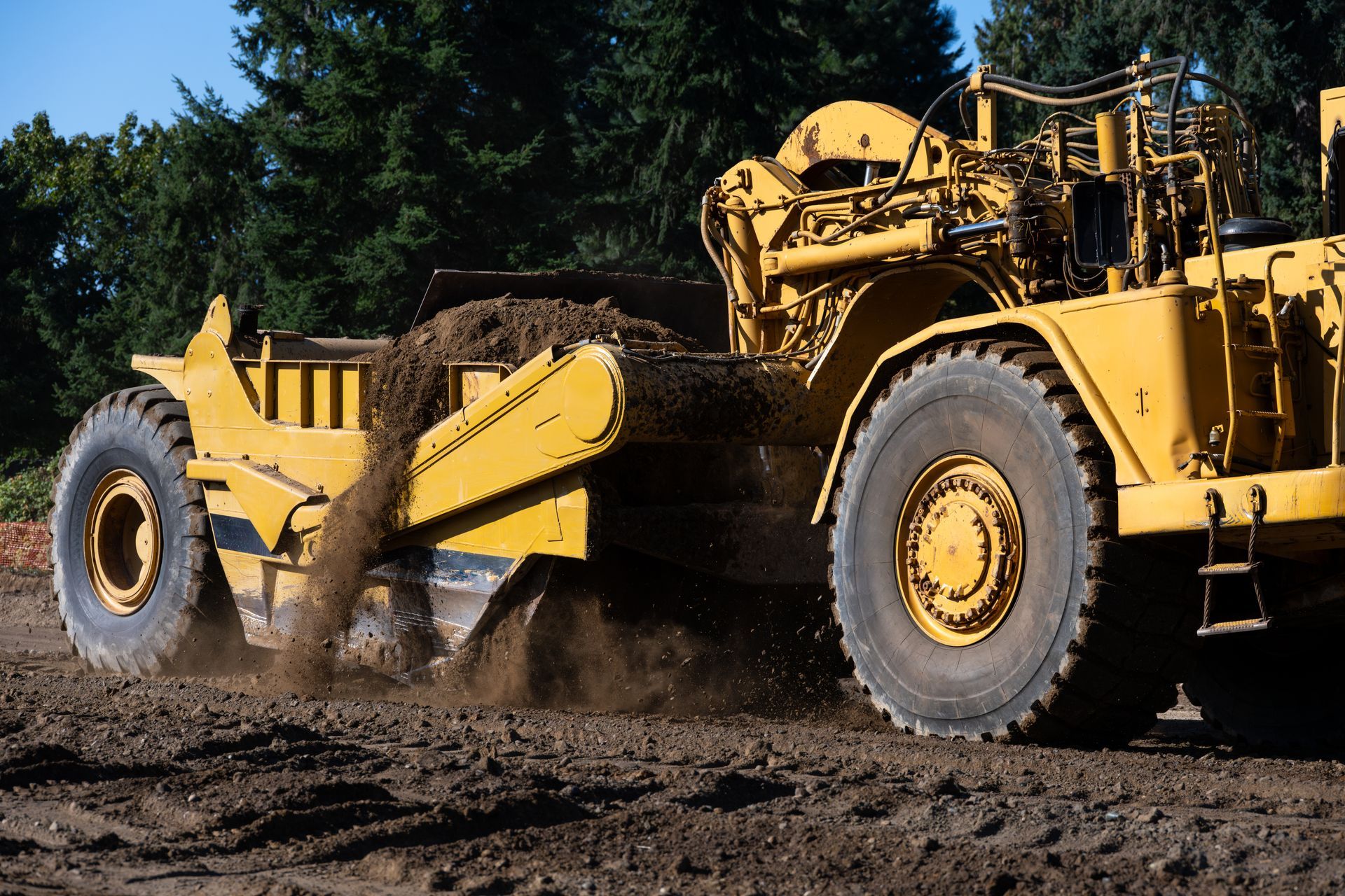 Yellow Scraper Machine Grading Dirt — Compass Equipment Hire in the Northern Rivers, NSW