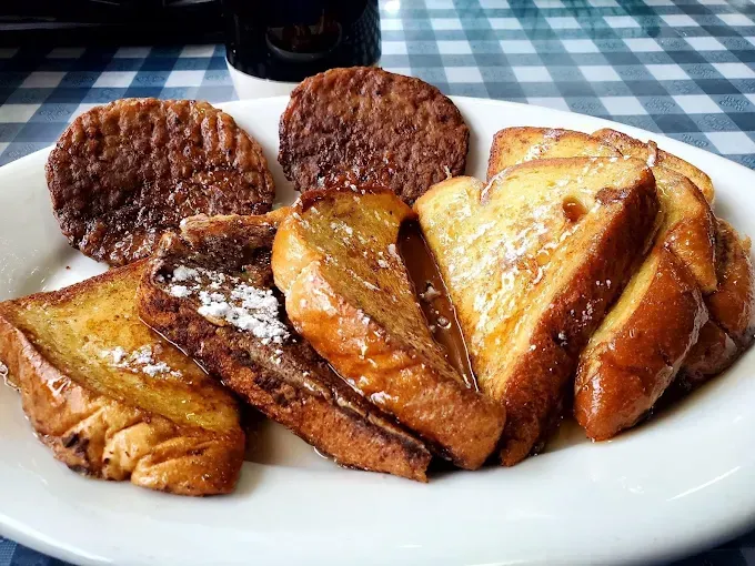 Plate of toast and grilled sausage patties on a white dish