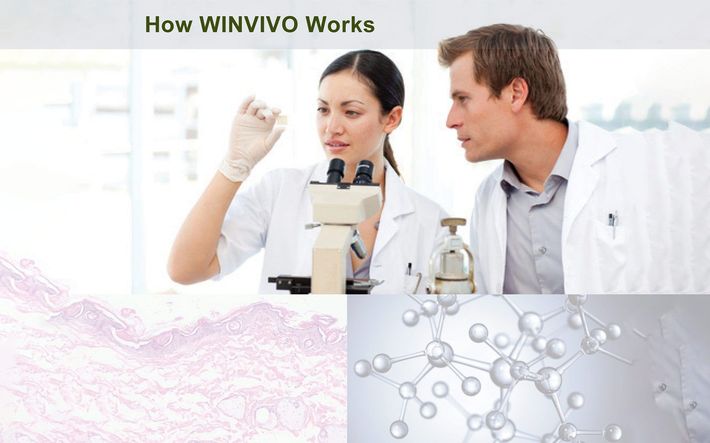 Two scientists examine a sample under a microscope in a lab setting.