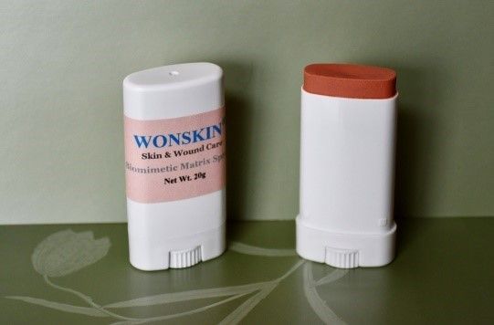 Two white tubes of WonSkin skin & wound care; one closed, one open showing brown cream.