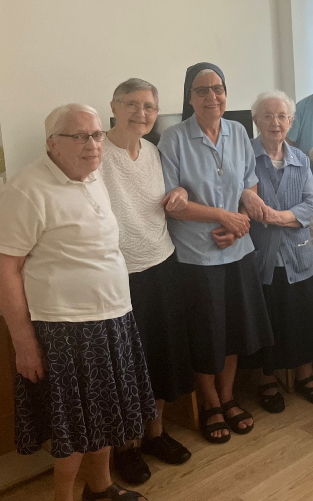 A group of older women are posing for a picture together.