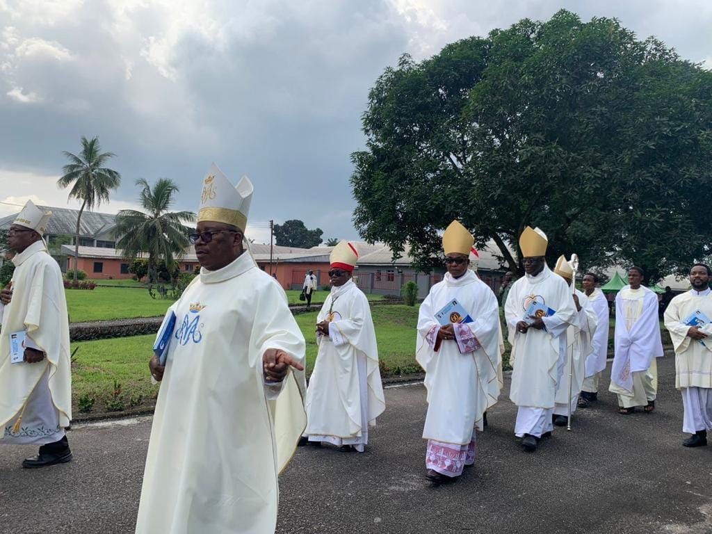 A group of priests are walking down a street.