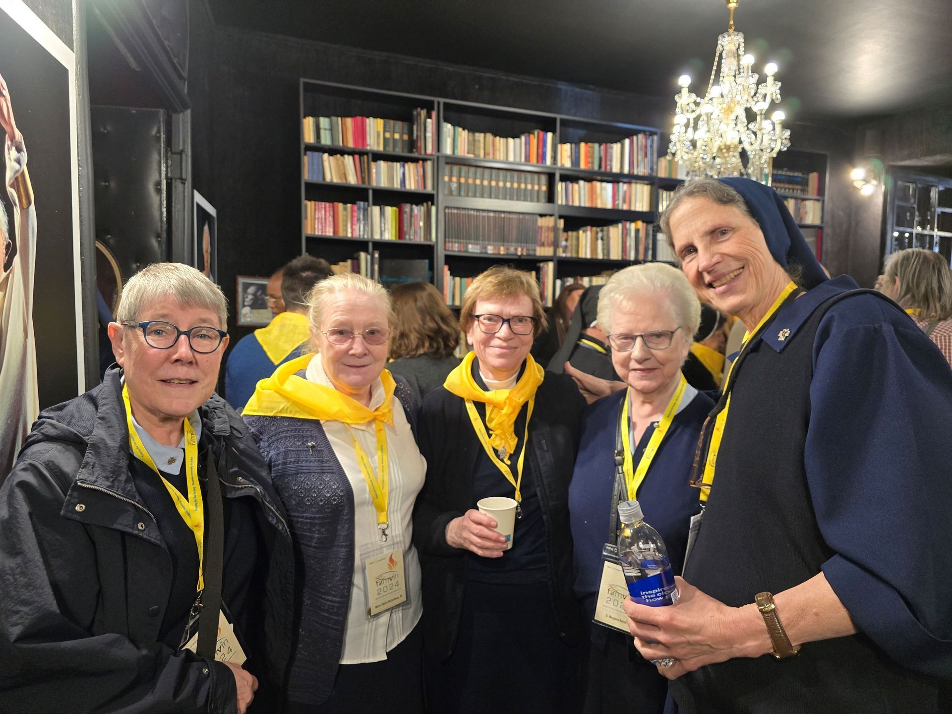 A group of women are posing for a picture in a library