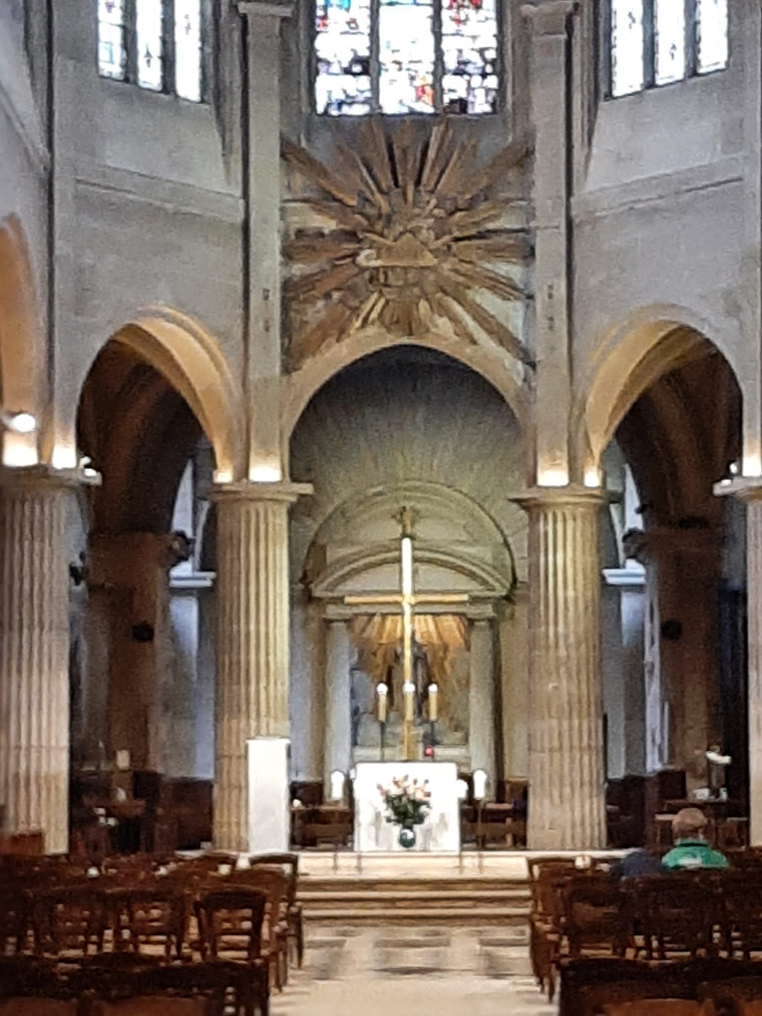 The inside of a church with a cross on the altar