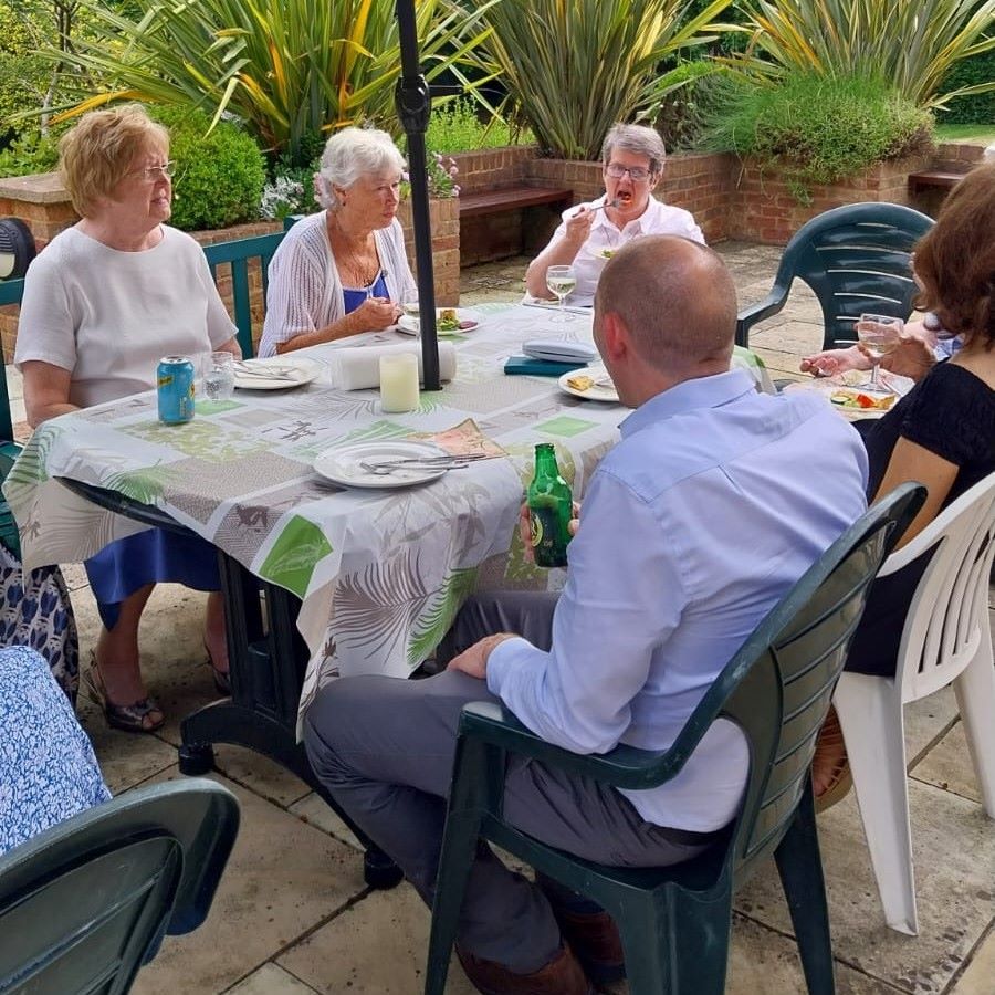 A group of people are sitting around a table eating food