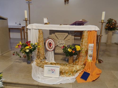 An altar in a church decorated with flowers and candles