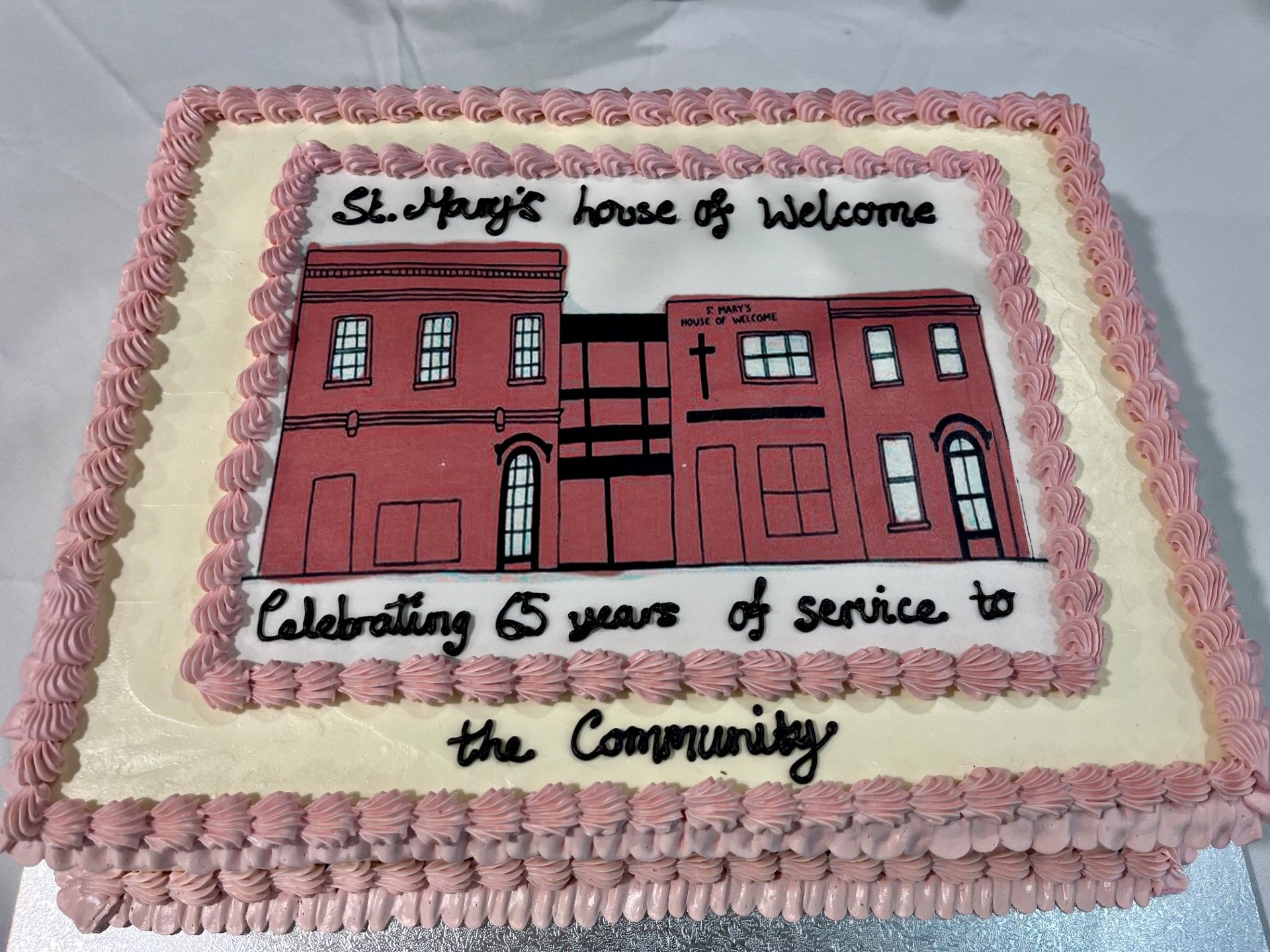 Cake decorated with building illustration, text 