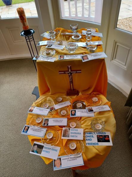 A table with a cross and candles on it