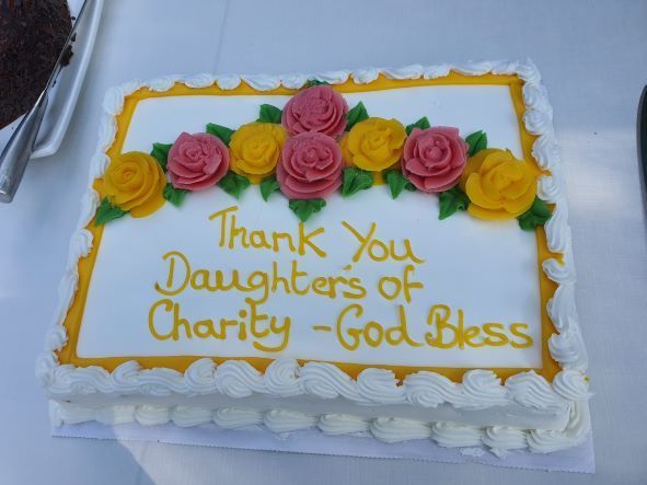 A cake that says thank you daughters of charity god bless