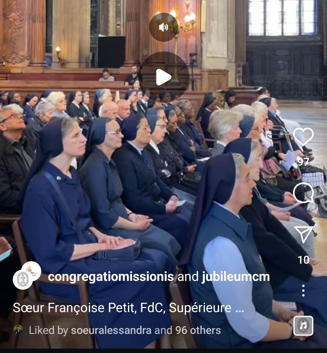 Nuns and others in a church setting, attending an event. Some wear blue habits.