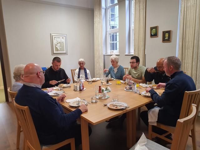 A group of people are sitting around a table eating food