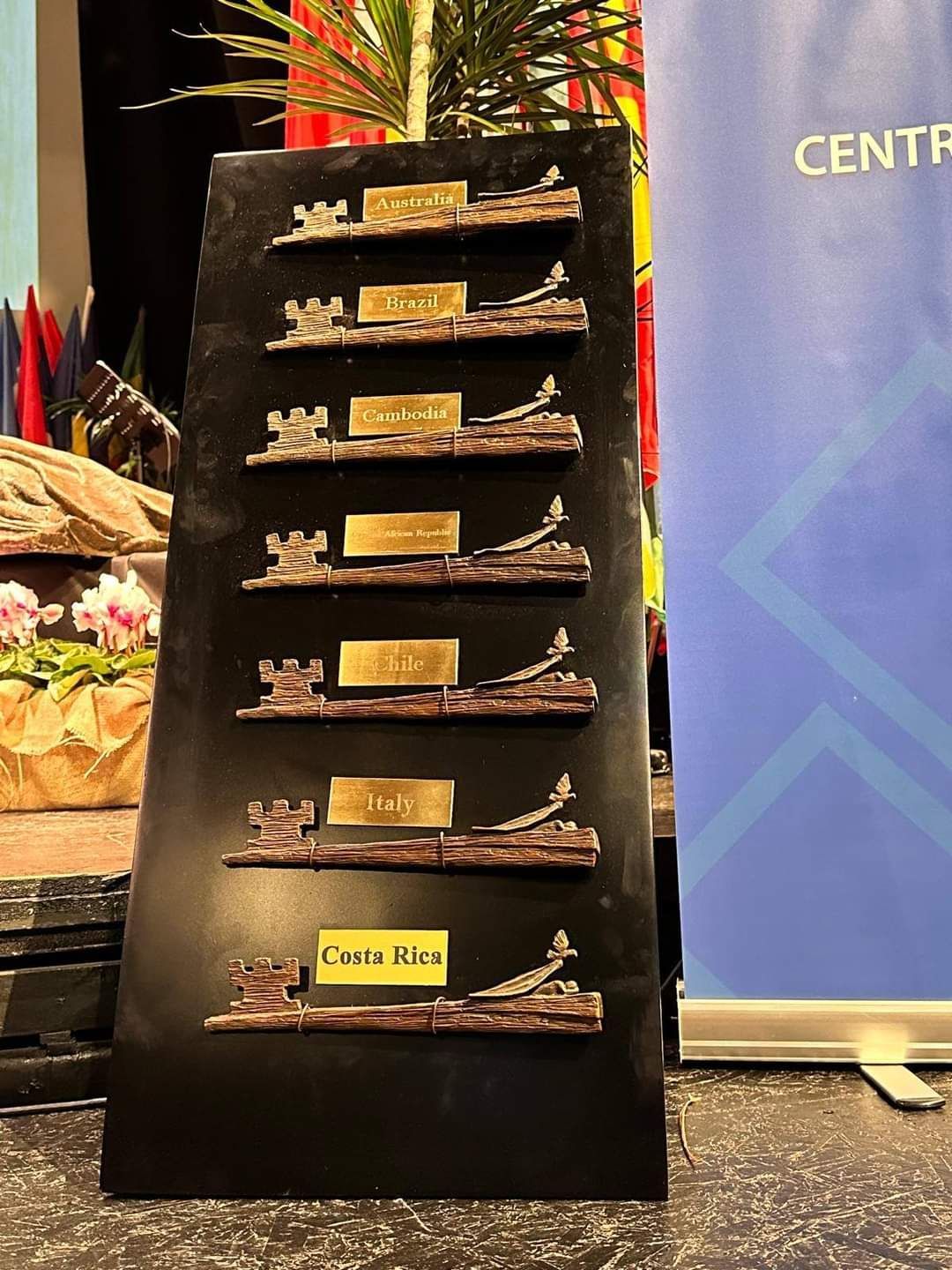 A row of trophies are lined up in front of a sign that says center