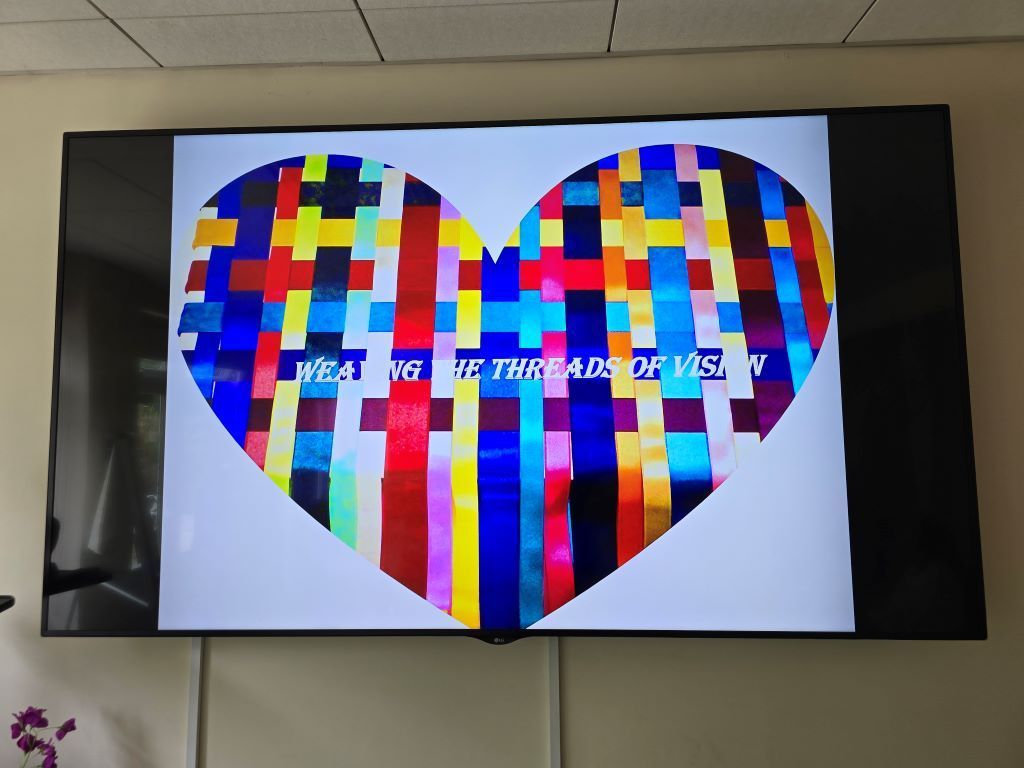 A tv screen shows a colorful heart and the words