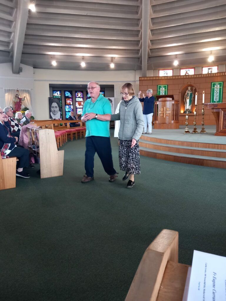 A man and a woman are walking in a church.