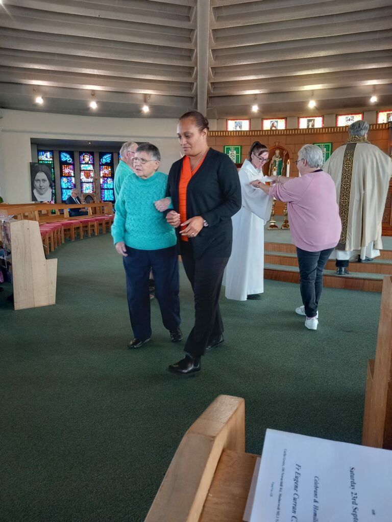 A group of people are standing in a church.