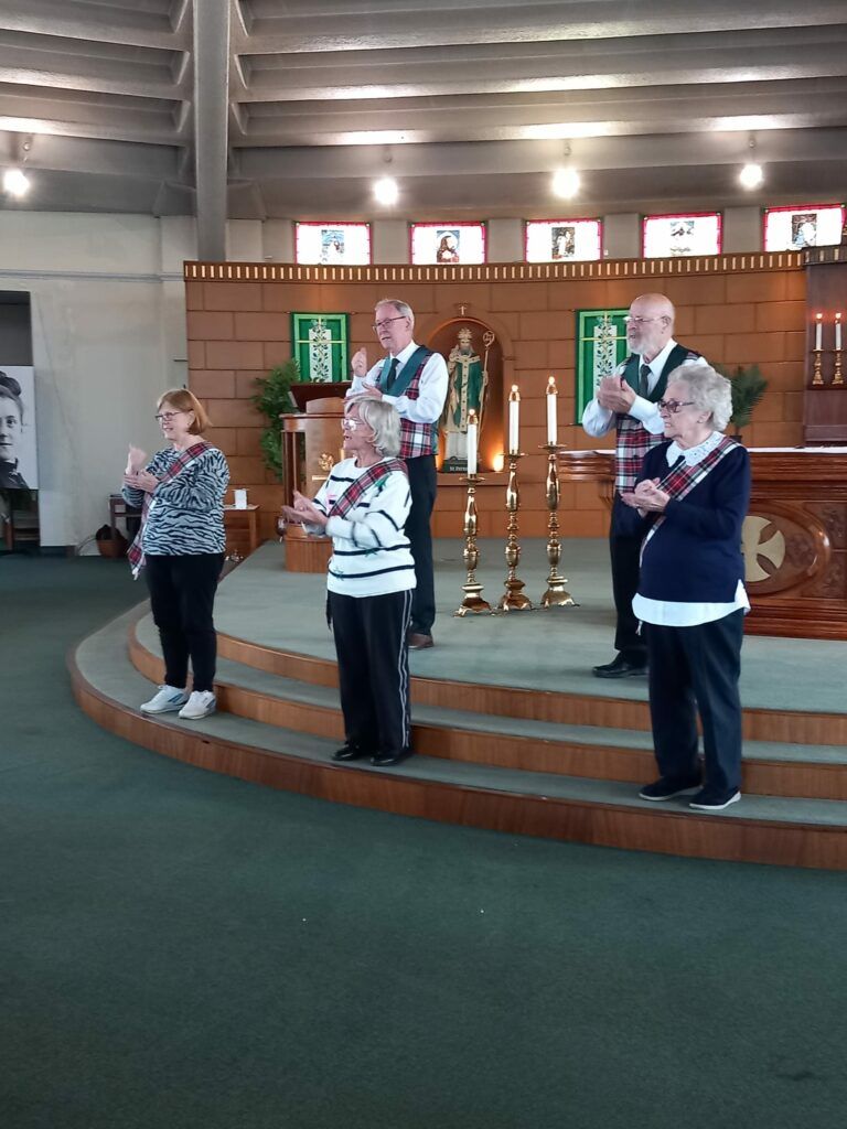 A group of people standing on a stage in a church