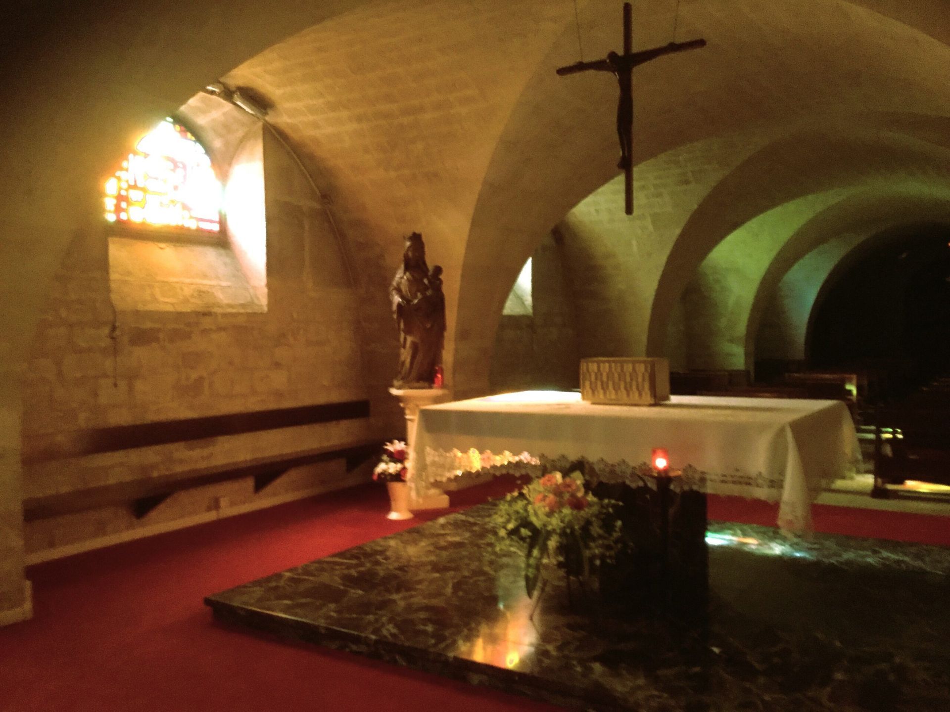 A church with a cross and a table with flowers on it