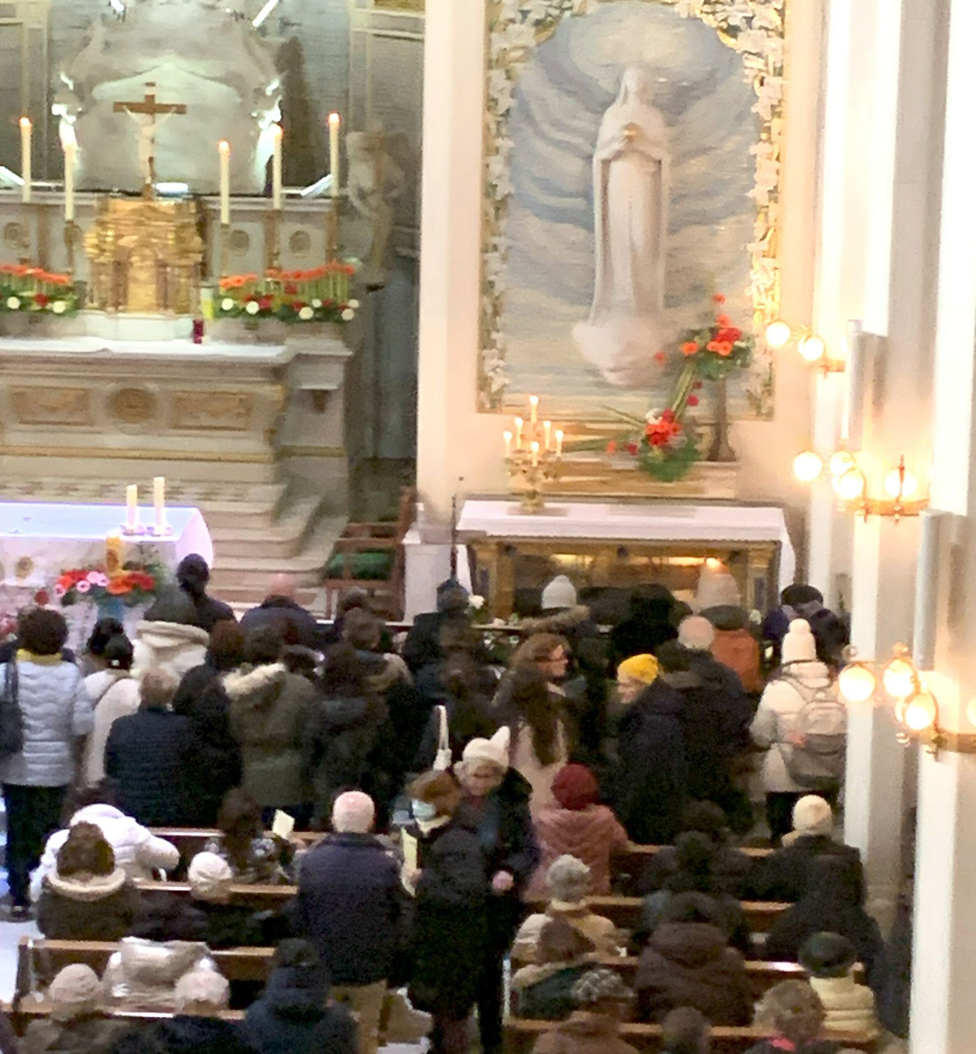 A large group of people are gathered in a church