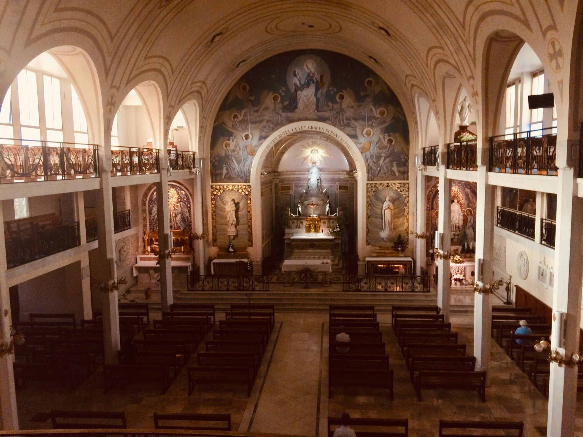 The inside of a church with a painting on the wall