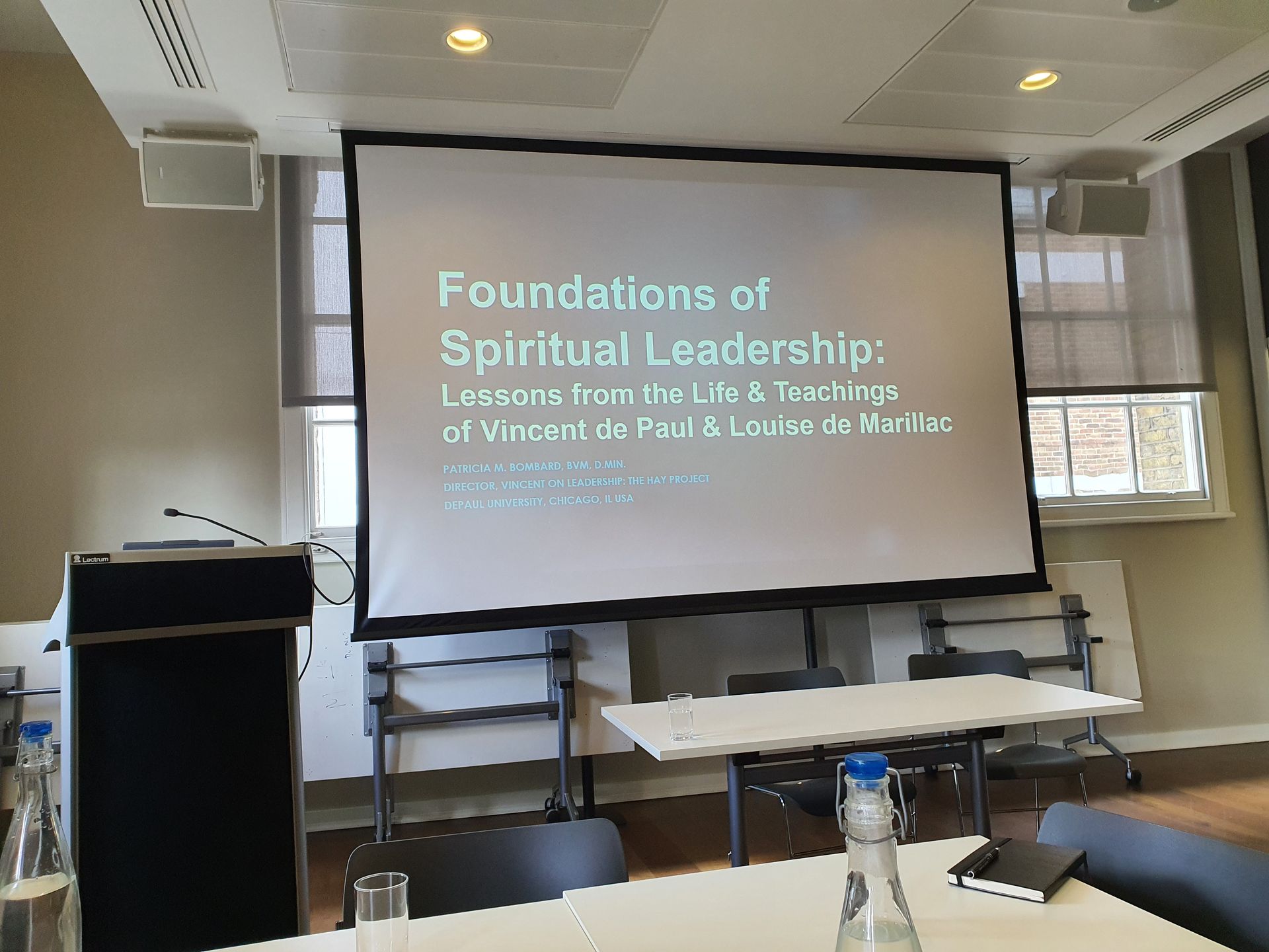 A room with a projector screen that says foundations of spiritual leadership