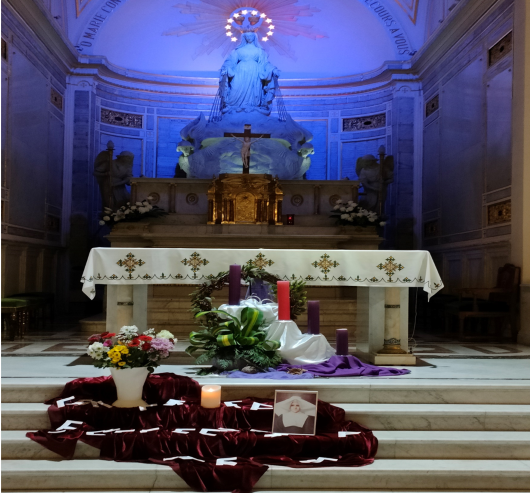 An altar in a church with flowers and candles