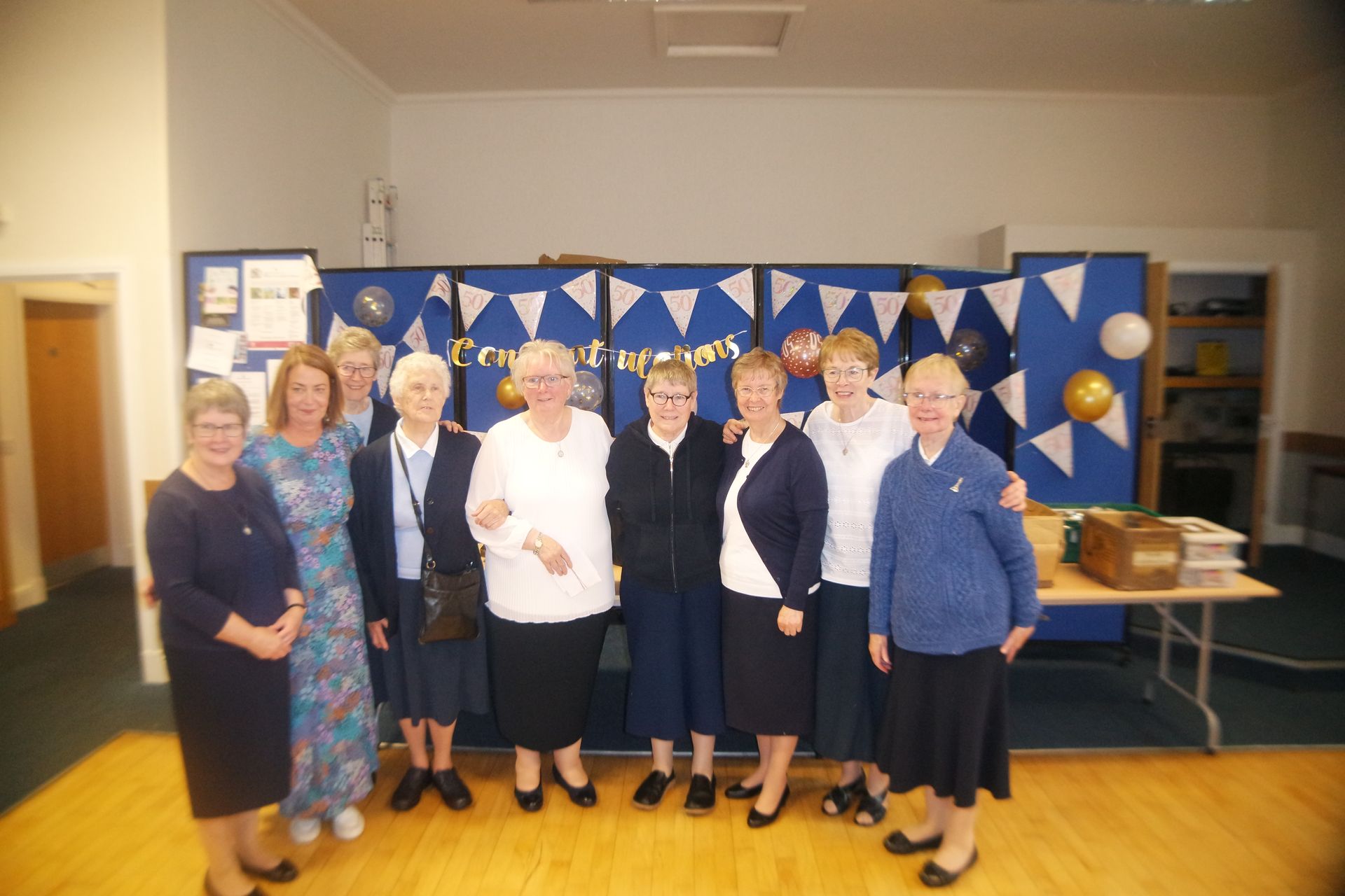 A group of women are posing for a picture in a room