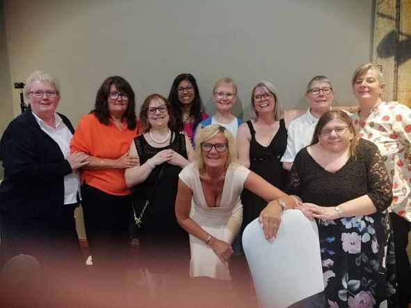 A group of women are posing for a picture together