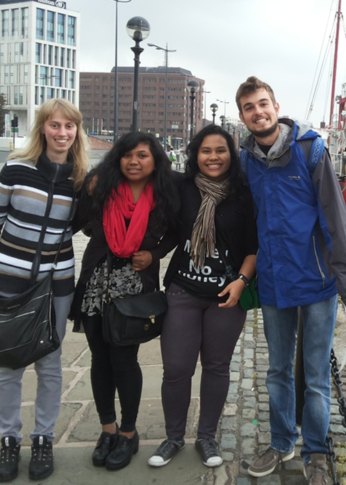 a group of people posing for a picture with one woman wearing a shirt that says no money
