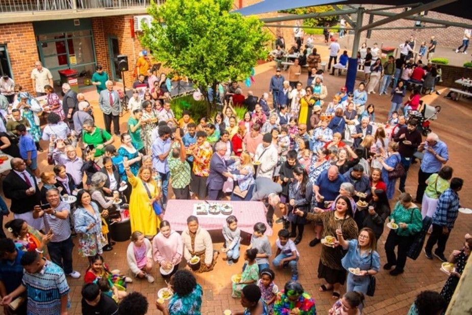A large group of people are gathered around a table.