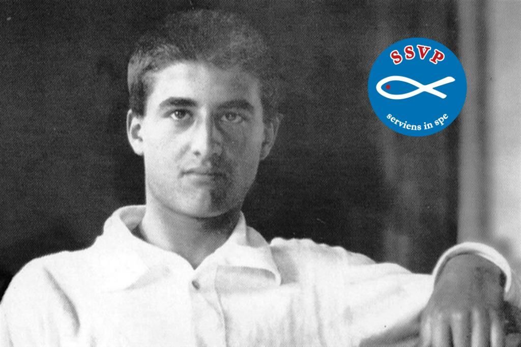 Young man, black and white photo, wearing white shirt, logo of fish symbol on blue background.