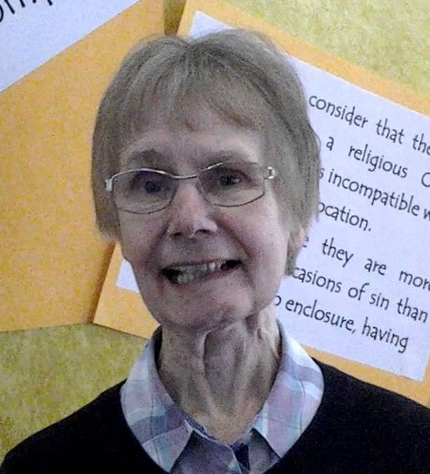 a woman wearing glasses is smiling