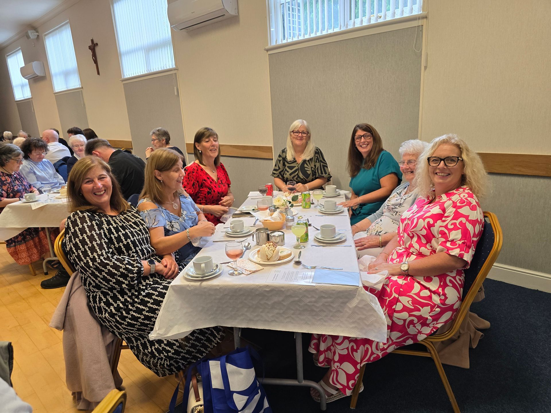 A group of women are sitting at a table in a room.