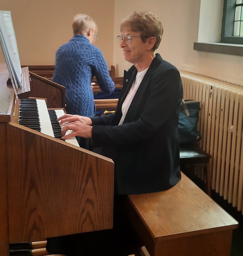 A woman is playing an organ in a church